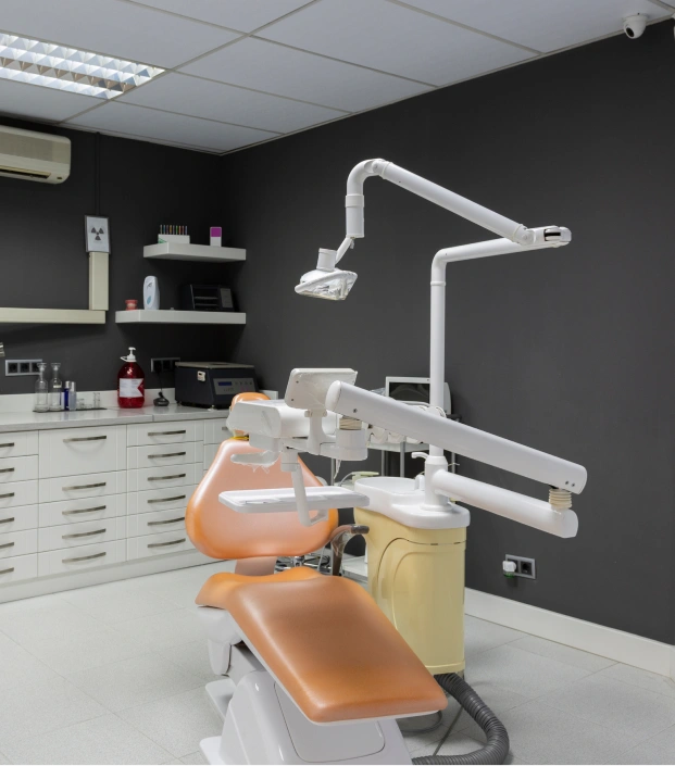 Modern dental treatment room featuring a dental chair and advanced dental equipment