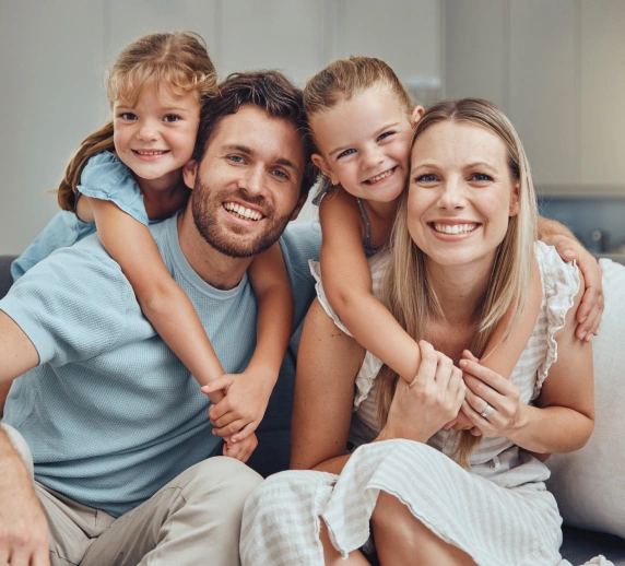 Family smiling together while learning about the Canadian Dental Care Plan