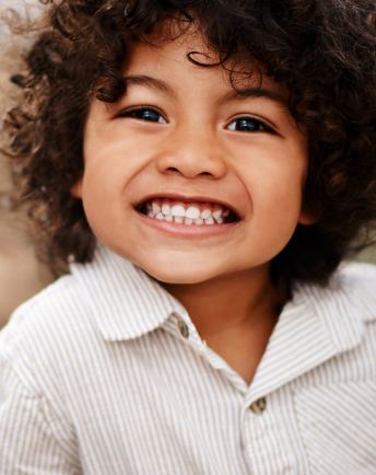 A child showing his healthy teeth