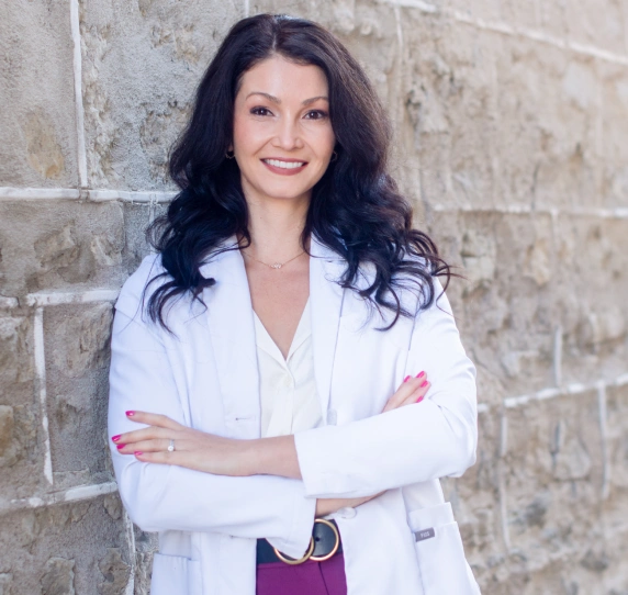 Dr. Julia Chrapka smiling with arms crossed at Alora Dental