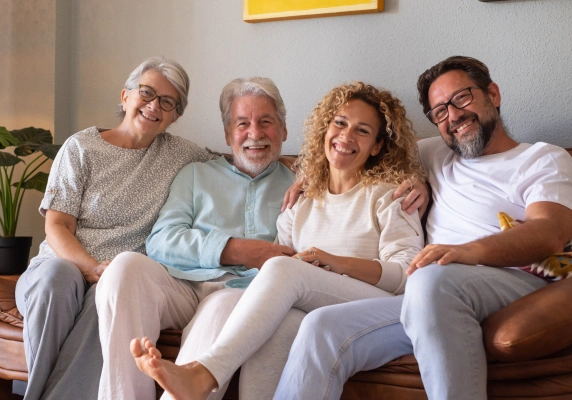 Family relaxing together while exploring dental insurance and financing options
