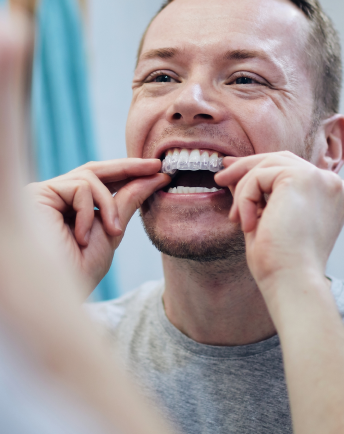A man wearing an aligner